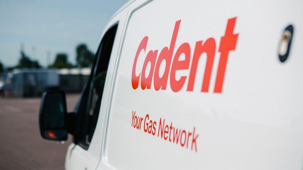 A Cadent white van, with writing on it. 
