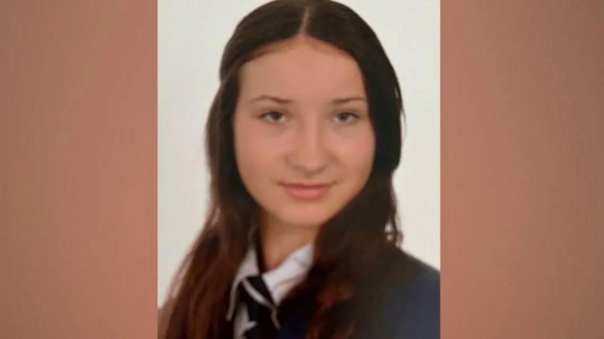 Scarlett Vickers smiling into the camera dressed in her school uniform and with her long, dark hair loose to her shoulders