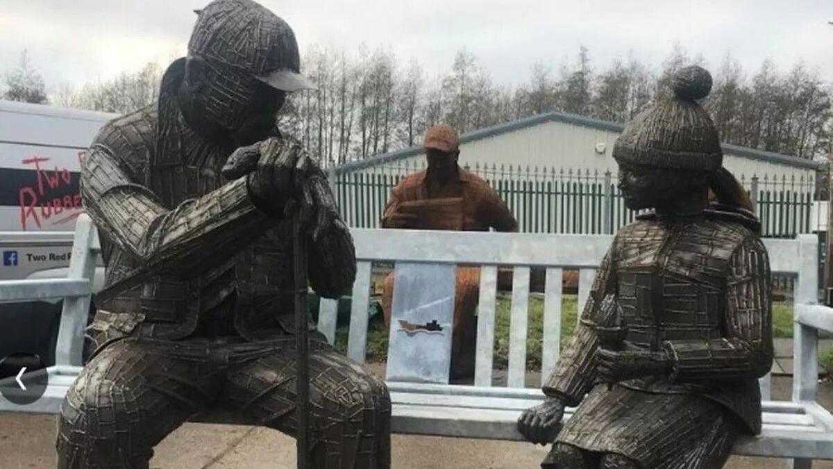 A sculpture of a young girl sitting with her grandfather overlooking the River Wear