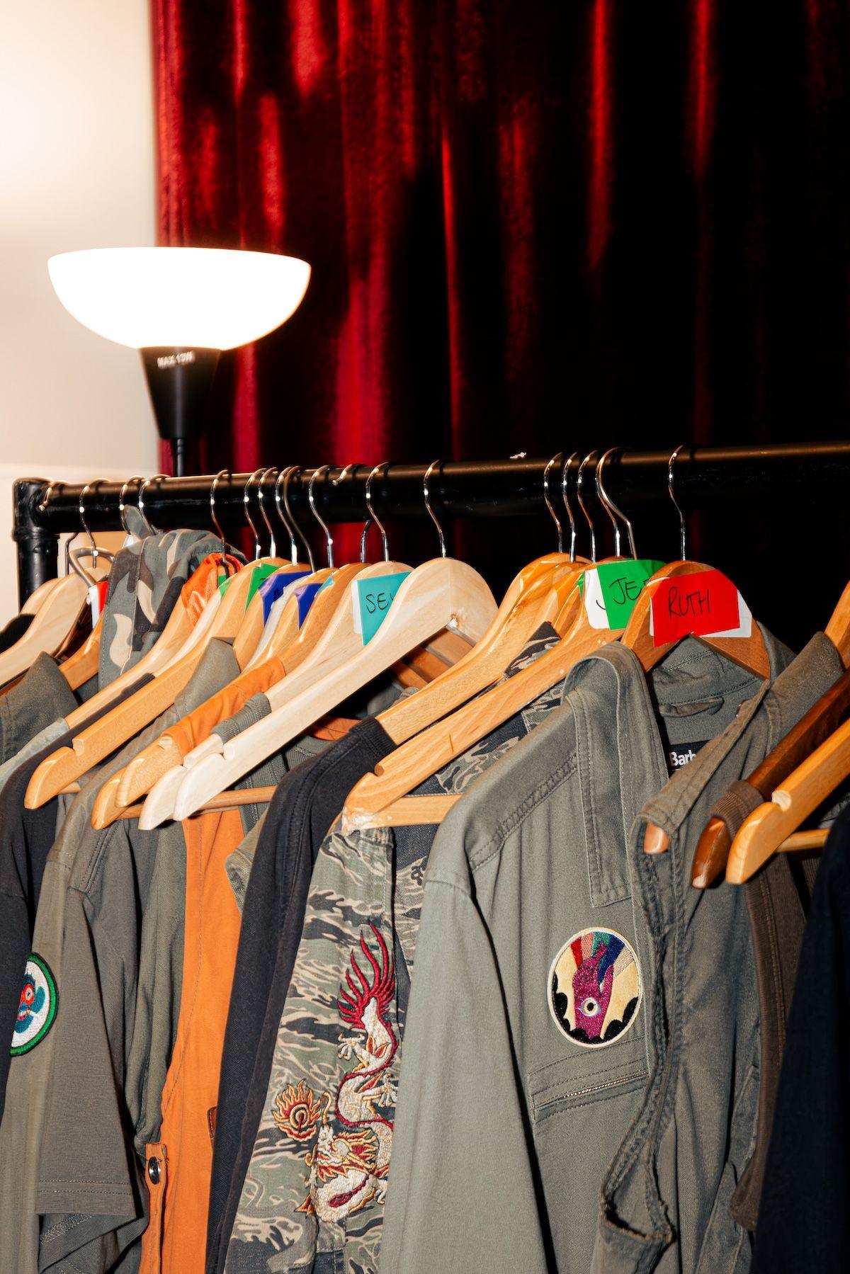 A clothing rack showing stage costumes for the Gorillaz stadium show