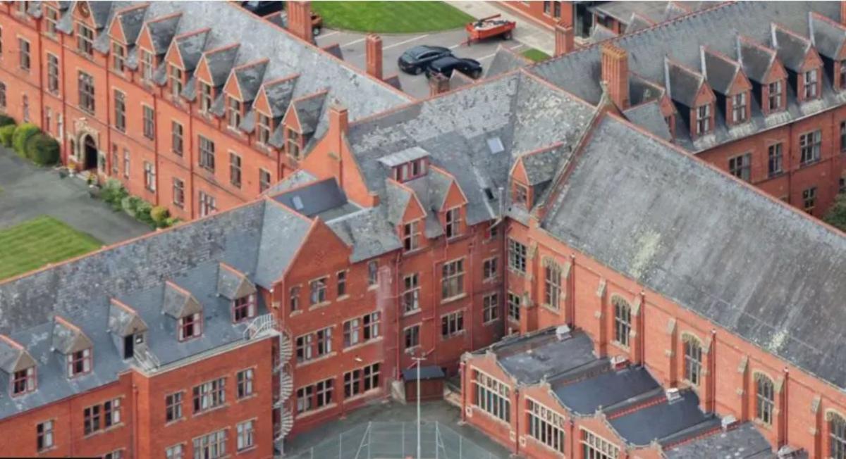 An aerial photo looking down on large, red-brick buildings at Ellesmere College's site in the Shropshire countryside