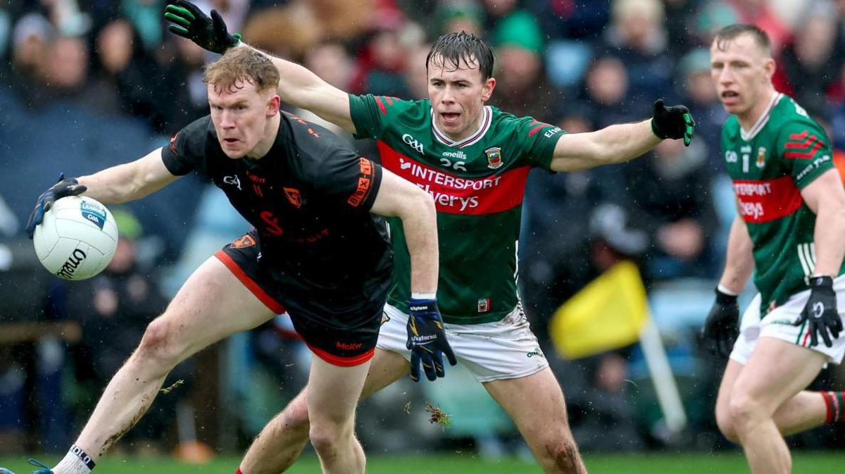 Armagh's Conor Turbitt gets past Paul Towey