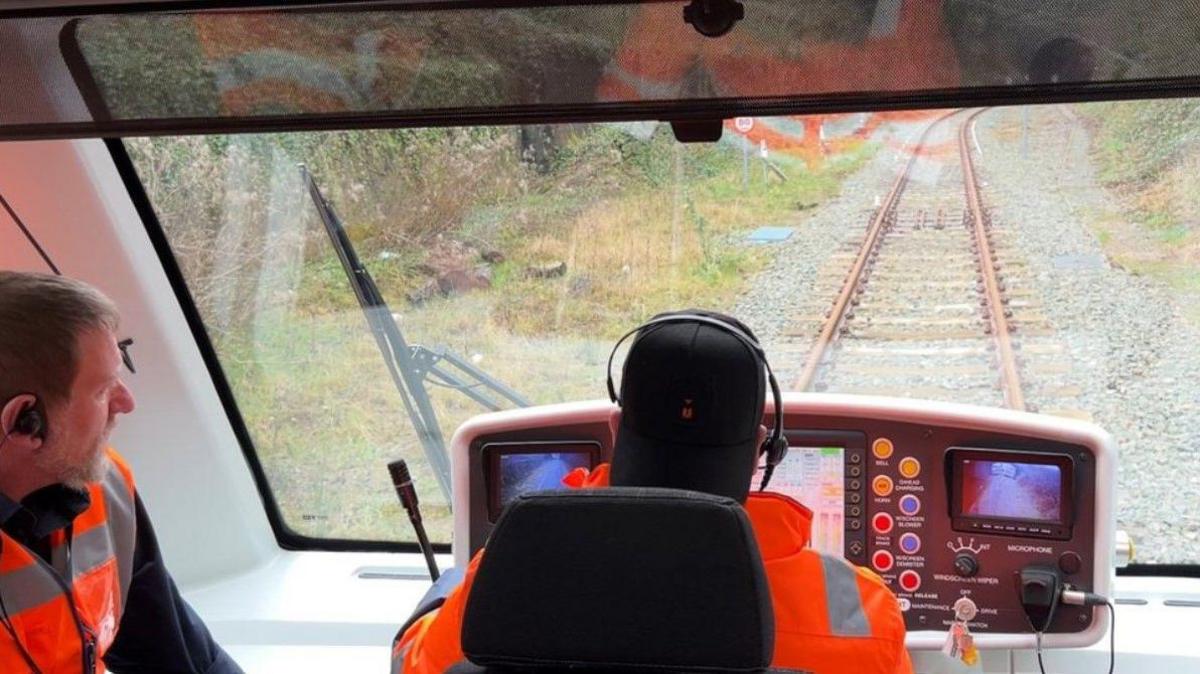 An operator driving a Very Light Rail vehicle