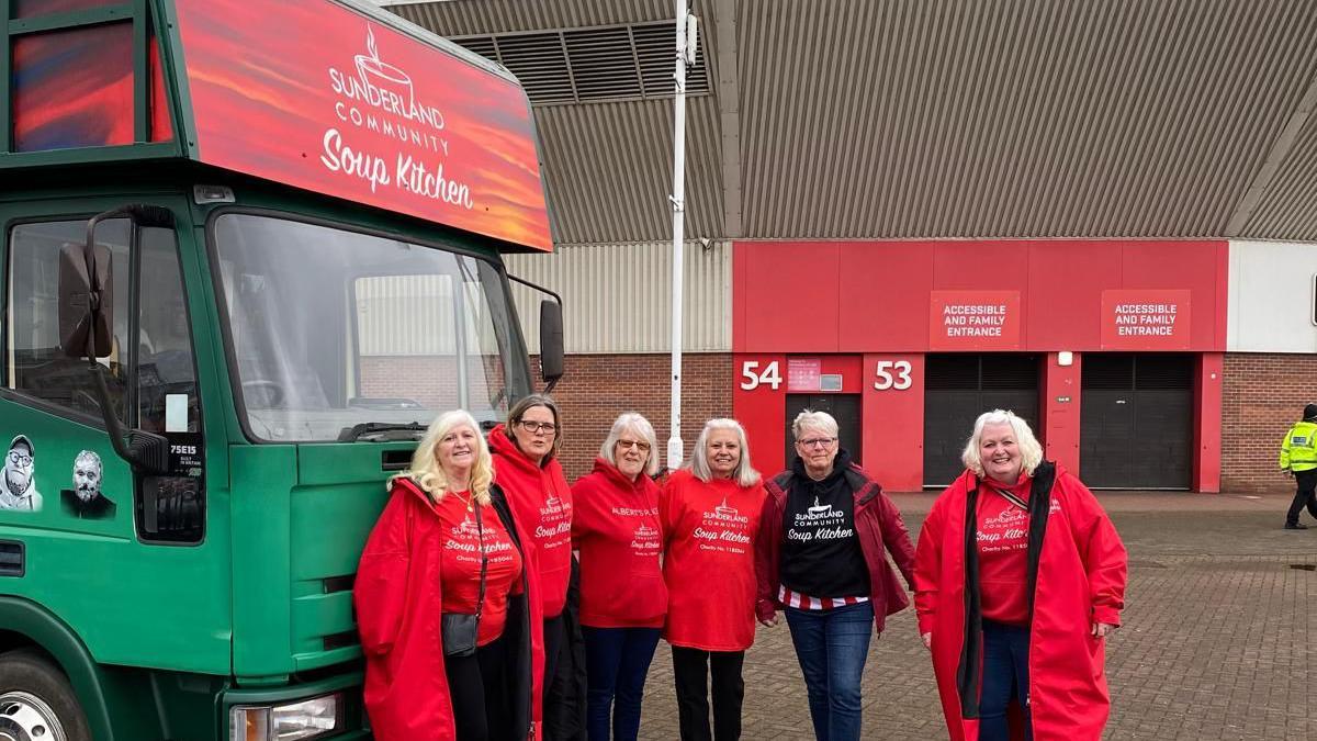 A group of people in front of a lorry saying Sunderland Soup Kitchen 