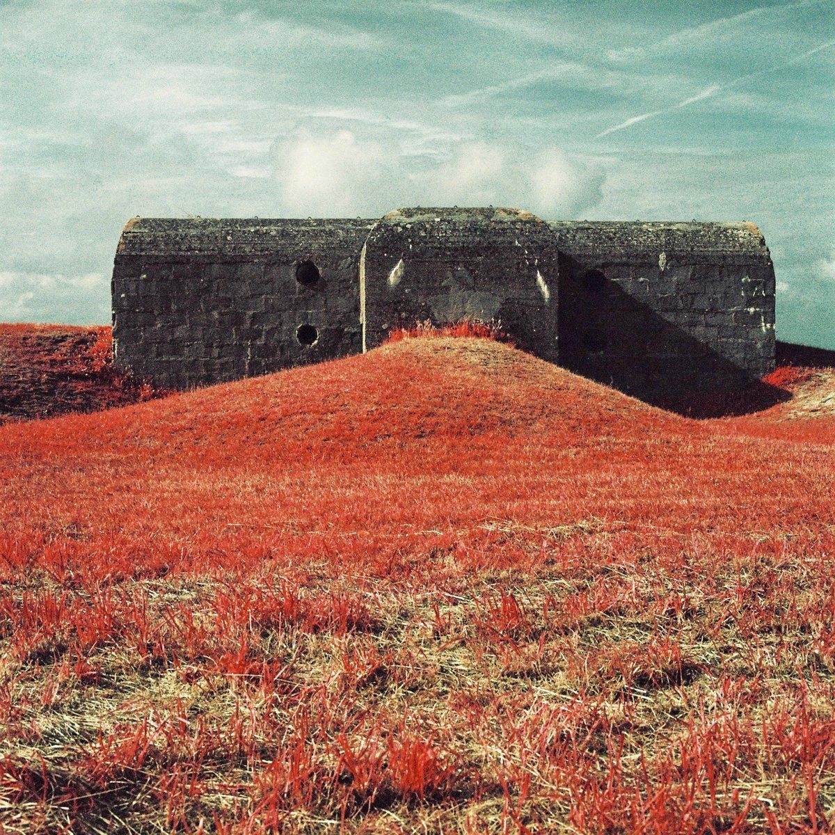 Infrared photograph of a bunker, surrounded by grass