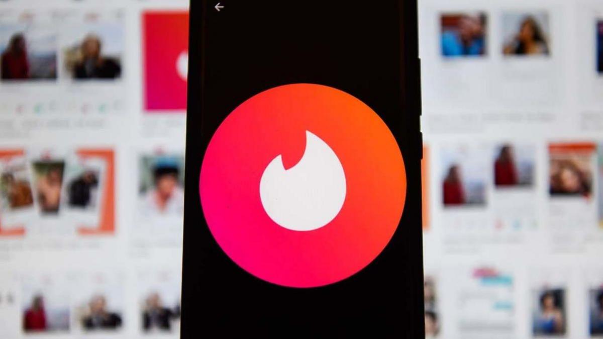 Tinder's logo displaying on a mobile phone.