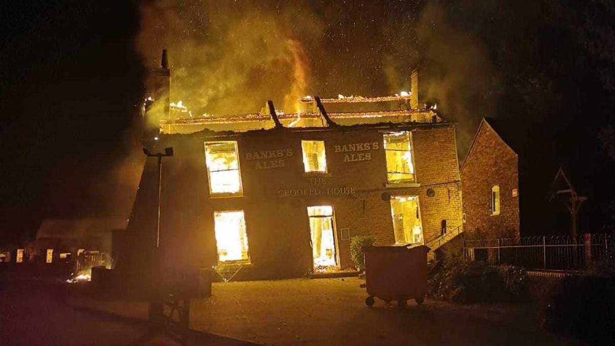 Wonky pub The Crooked House engulfed by flames
