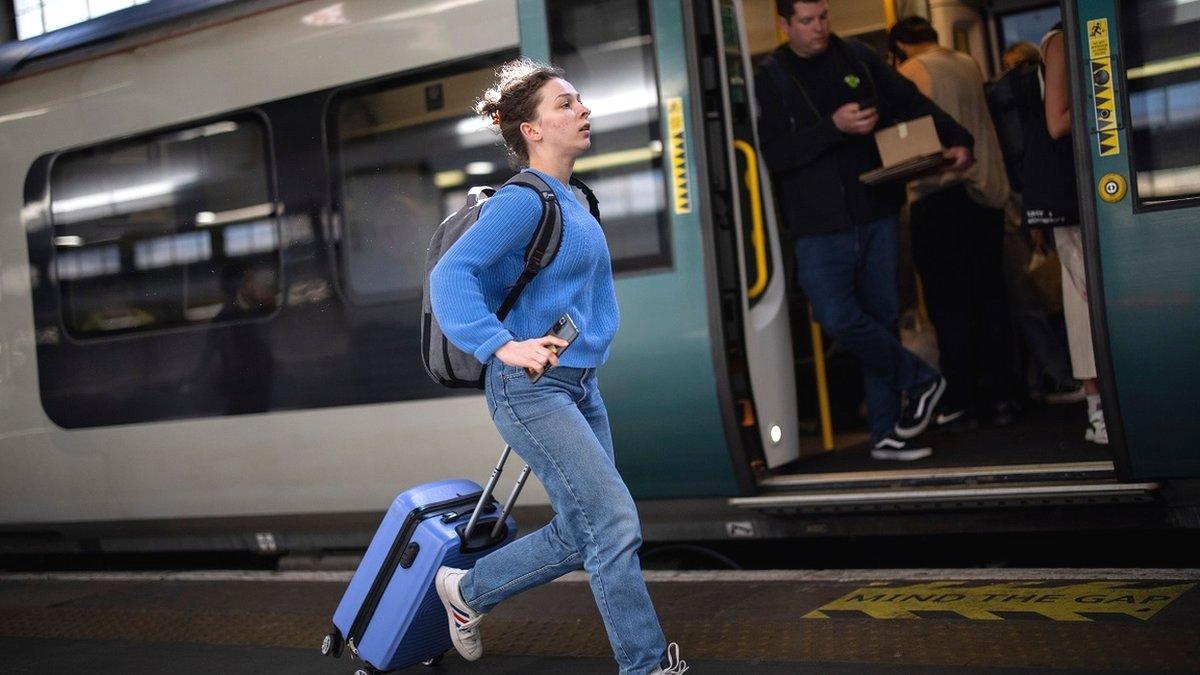 A woman runs for a train