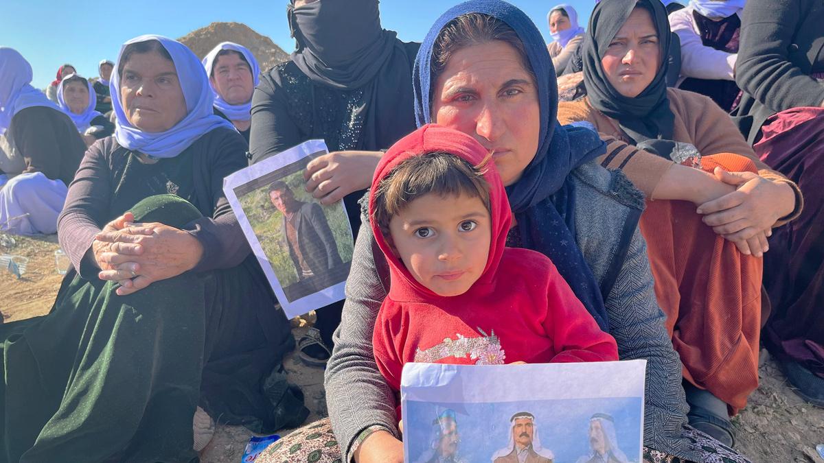 Yazidi women in Iraq by a suspected mass grave site