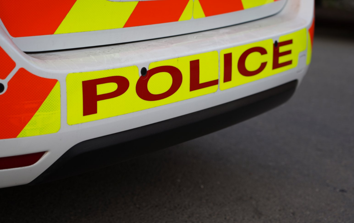 The bumper of a police car with "police" written in big red letters.