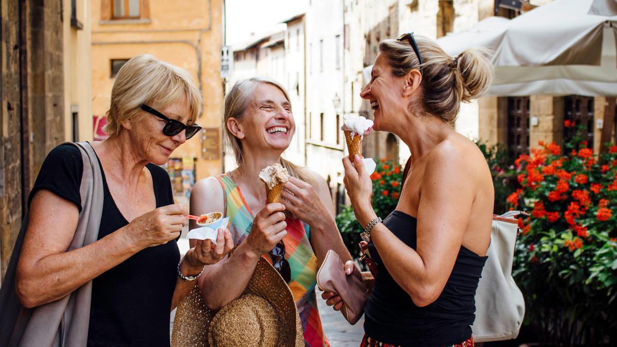 Friends enjoying ice cream in a European street