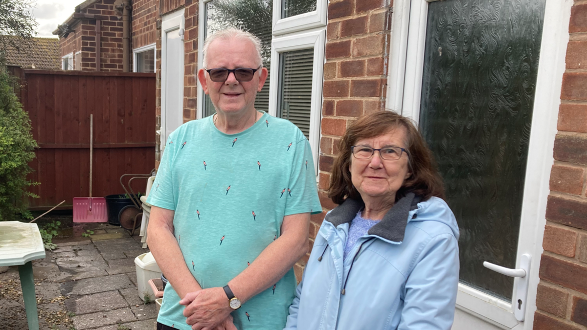 Elsie Beamont in a blue jacked with tenant Roger, who is wearing a green tshirt and sunglasses