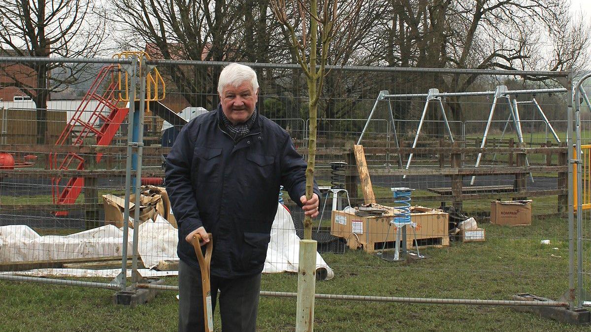 Amber Valley council leader Chris Emmas-Williams holding a tree 