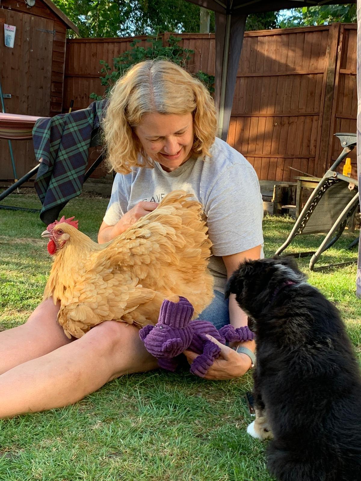 Sarah Chidwick at her home in Claverham with one of her chickens and her dog