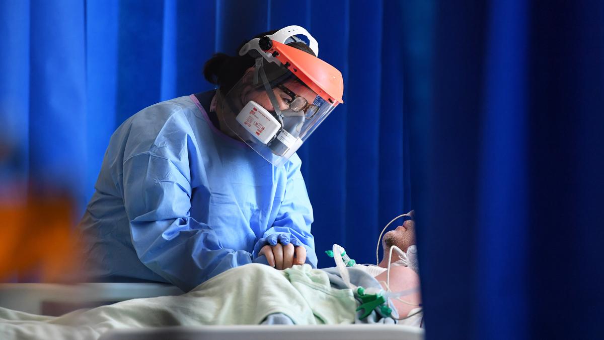 A member of staff cares for a patient in the Intensive Care Unit of Royal Papworth Hospital, Cambridge, UK, 5 May 2020