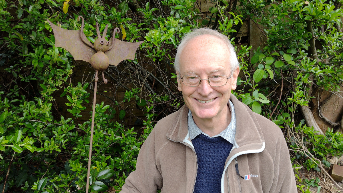 Ross Baker standing in his garden with a metal bat