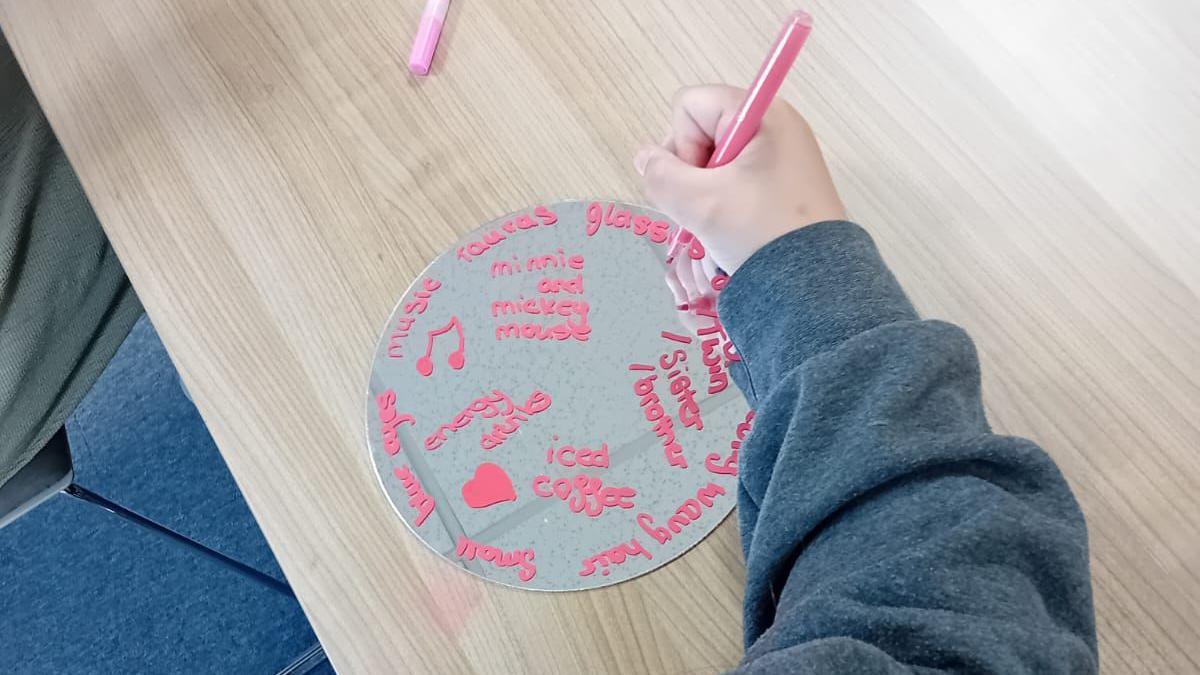 A child writing on a wheel, with an arm outstretched. 