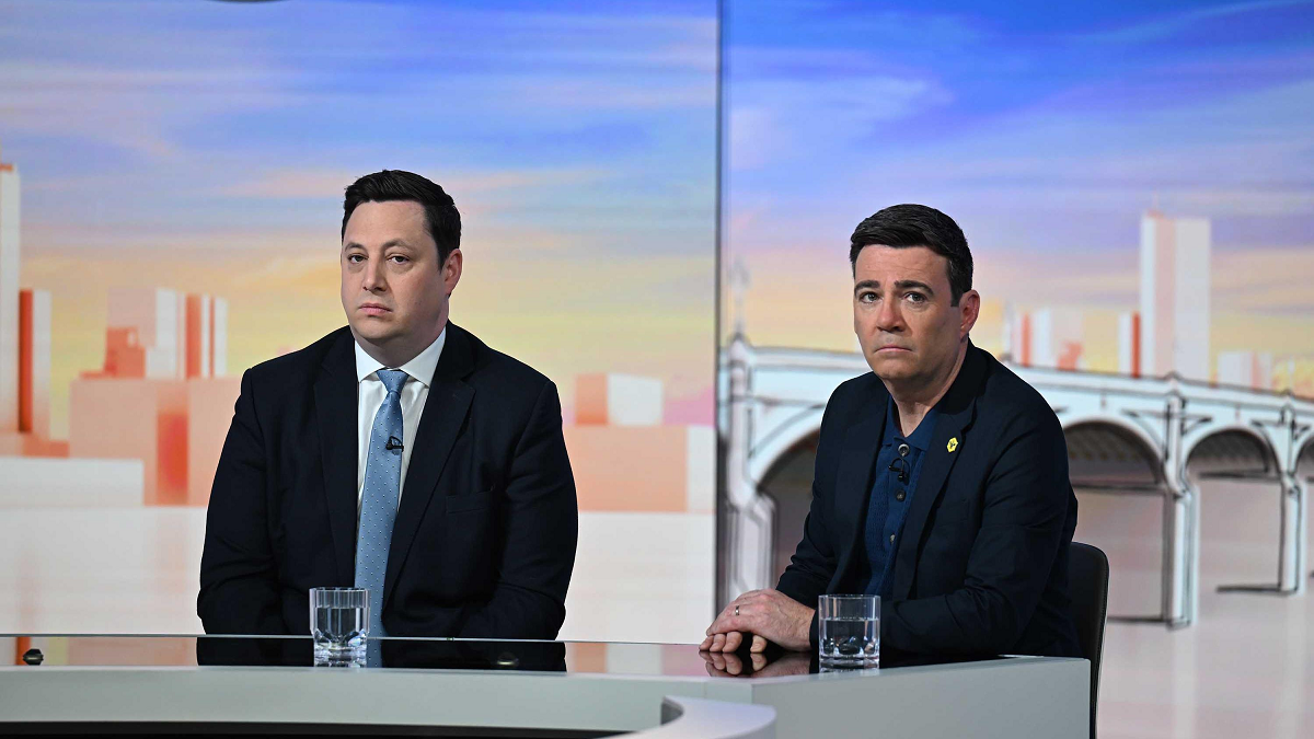 Lord Houchen and Andy Burnham on the set of Sunday with Laura Kuenssberg in 2025. Houchen, sitting on the left, is wearing a dark suit and pale blue tie. Burnham has a dark jacket with a dark blue suit.