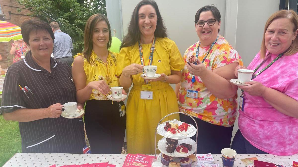 Staff and attendees enjoying their afternoon tea