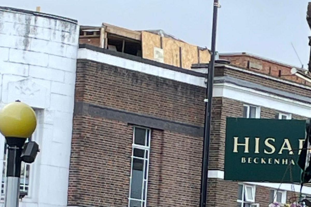 A wooden structure sits on the top of the roof of the building that caught fire on the Beckenham high street.