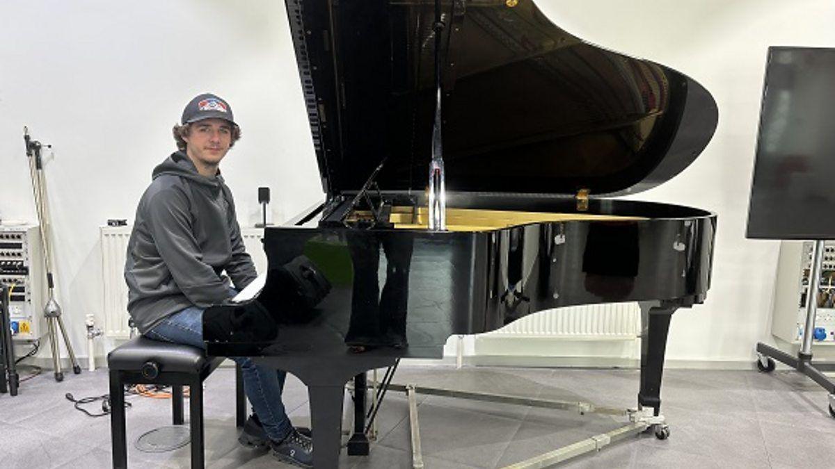 Brad Kellaher sitting at a piano