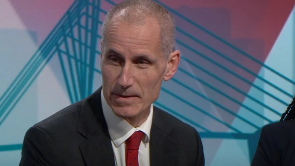 Labour MP Bill Esterson, wearing a dark suit, white shirt and red tie, speaks in a BBC studio