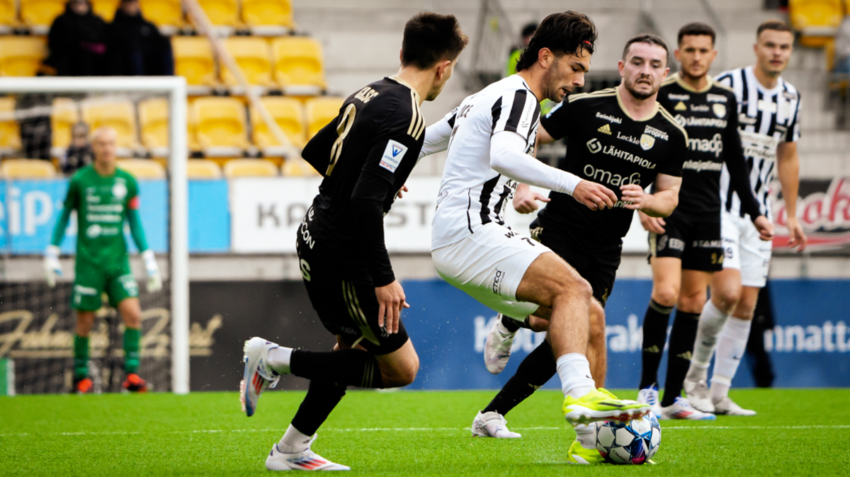 Alfie Cicale of VPS Vaasa controls the ball while SJK's Lewis Strapp looks on