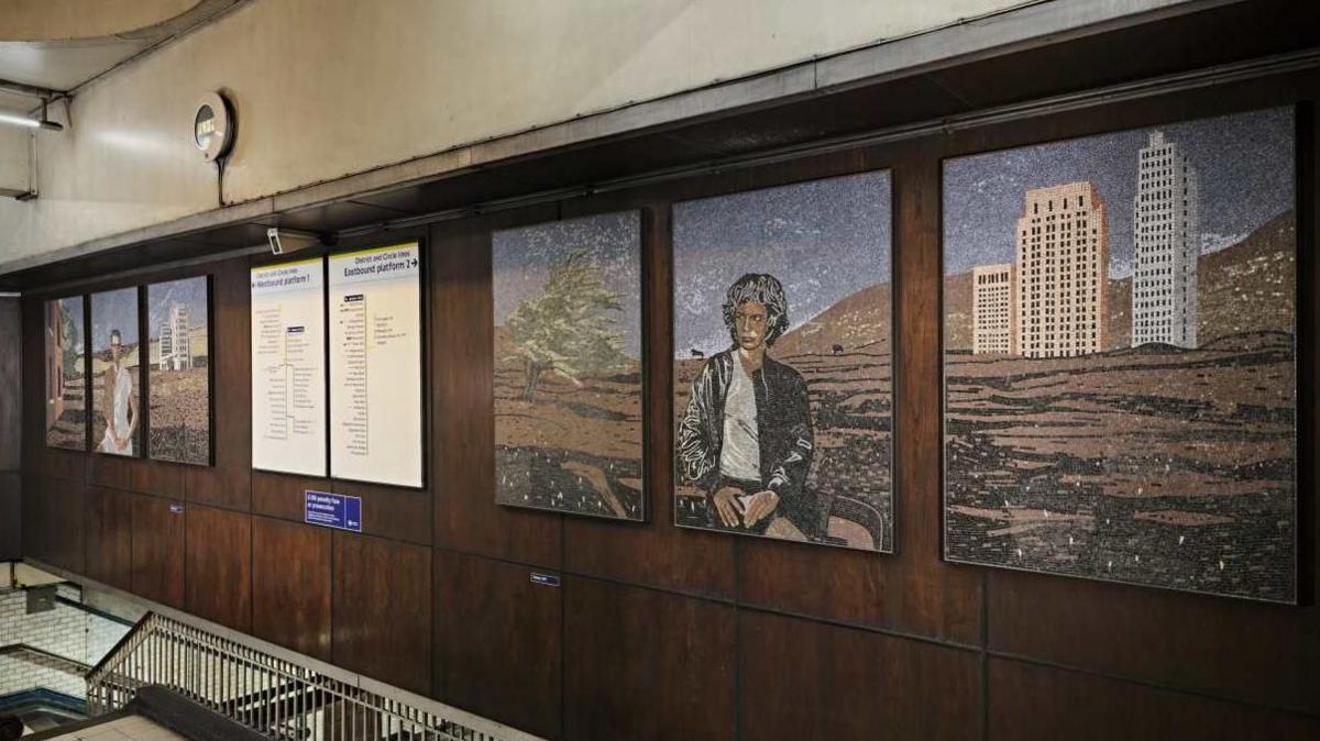 Above the entrance to the platforms at St James' station, two artworks of three panels each on either side of the information boards. 