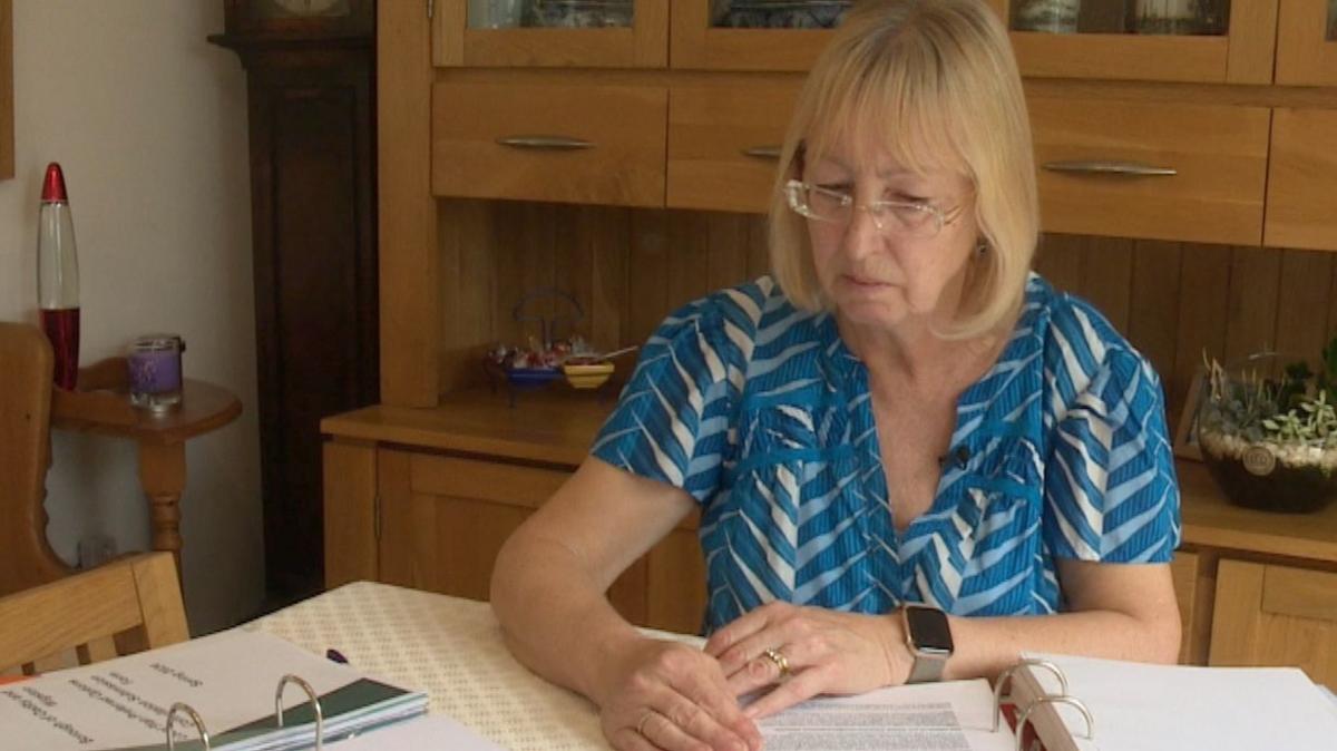 Karen sat at her desk looking over her paperwork for her home