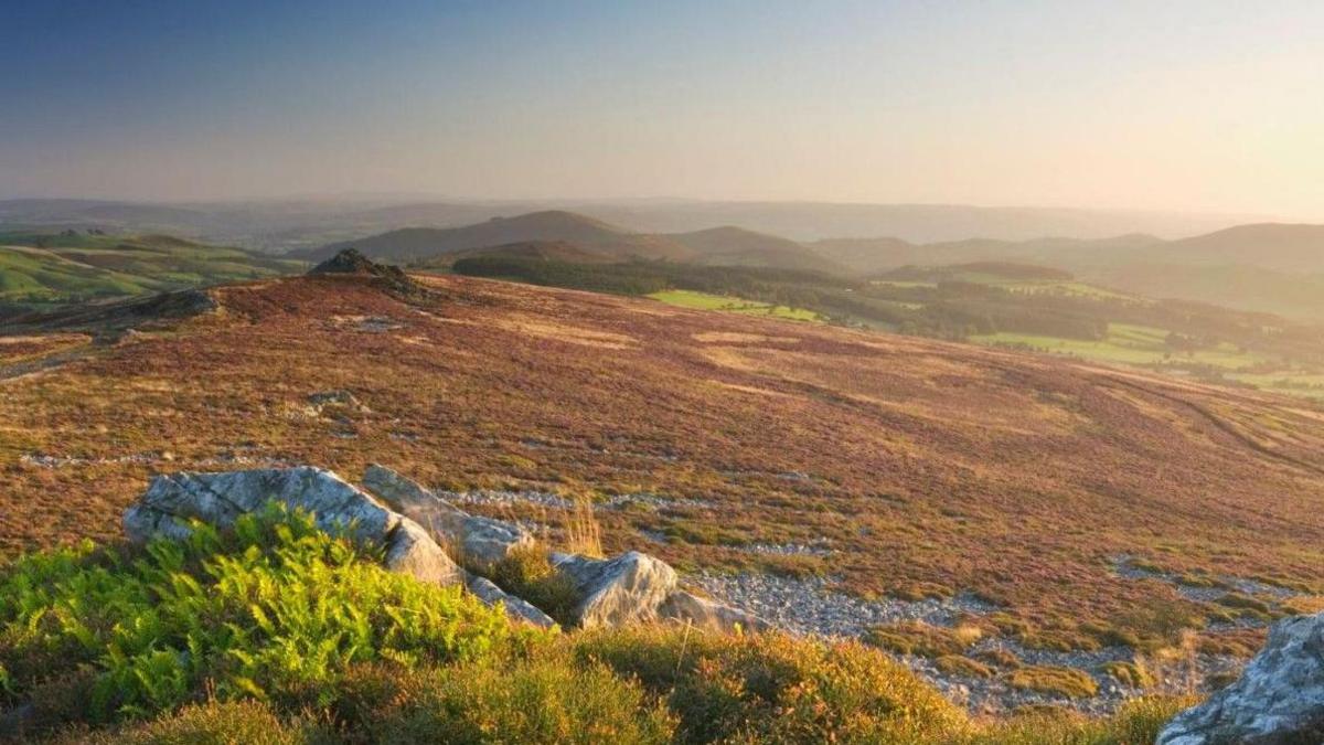 A landscape photo of hills and land over a large area. 