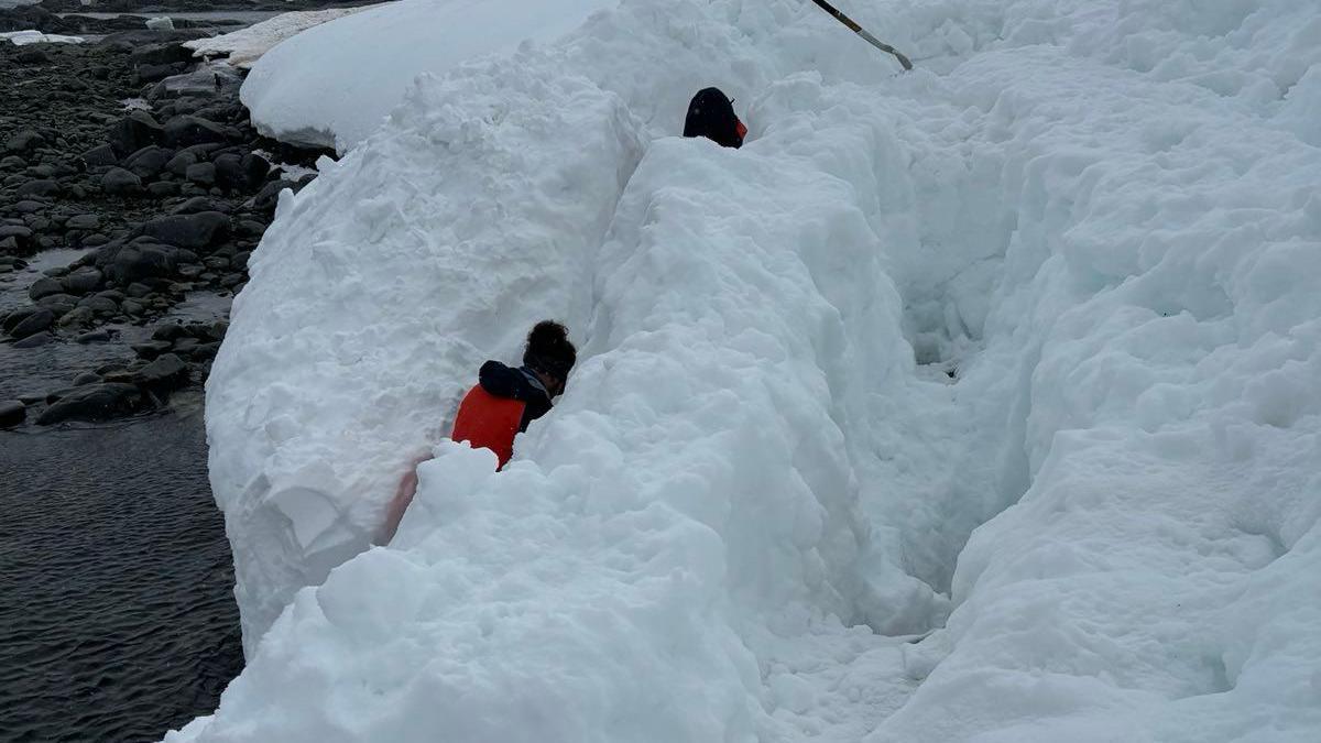 Two team members digging a path in the snow