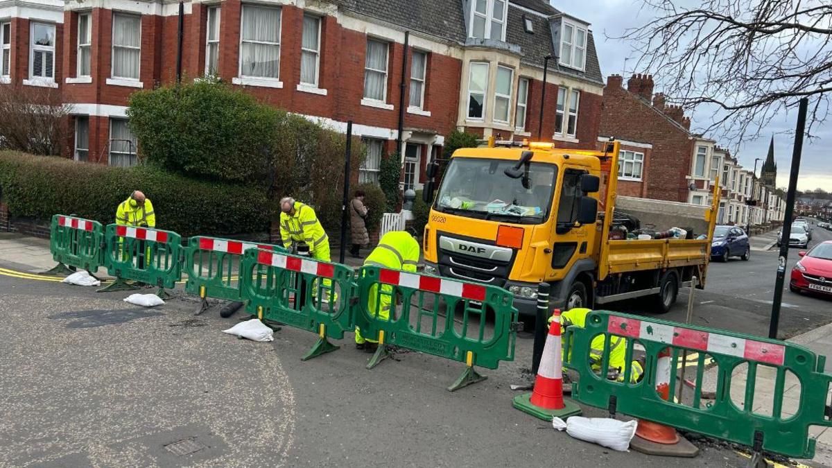 Workmen removing traffic measures in Jesmond