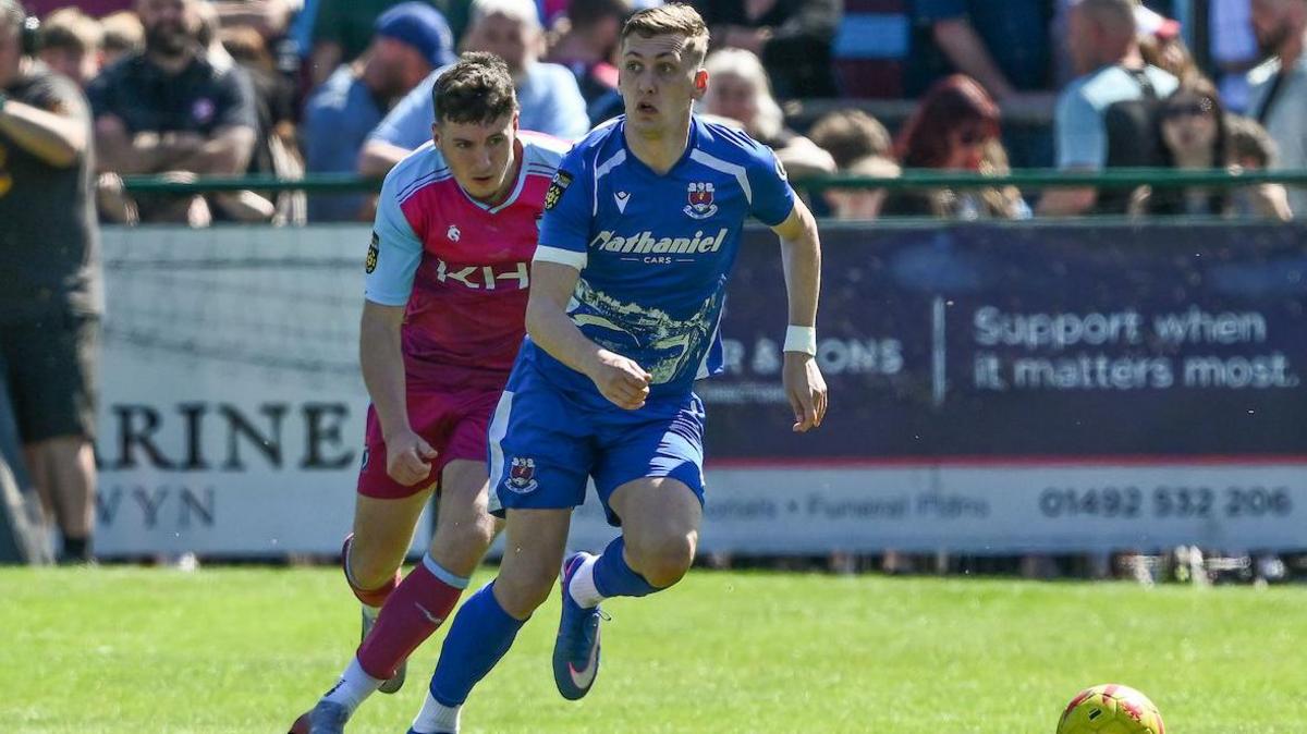 Penybont's Nathan Wood is pursued by Colwyn Bay's Matty Hill