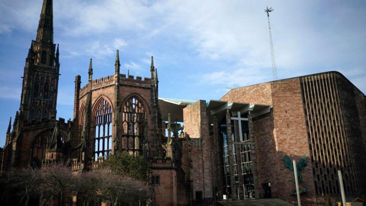 The remains of the bombed-out original Coventry Cathedral next to its modern replacement on the right