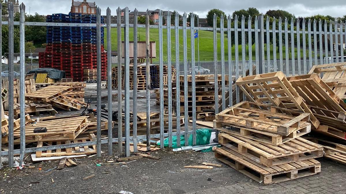 Pallets beside a gate 