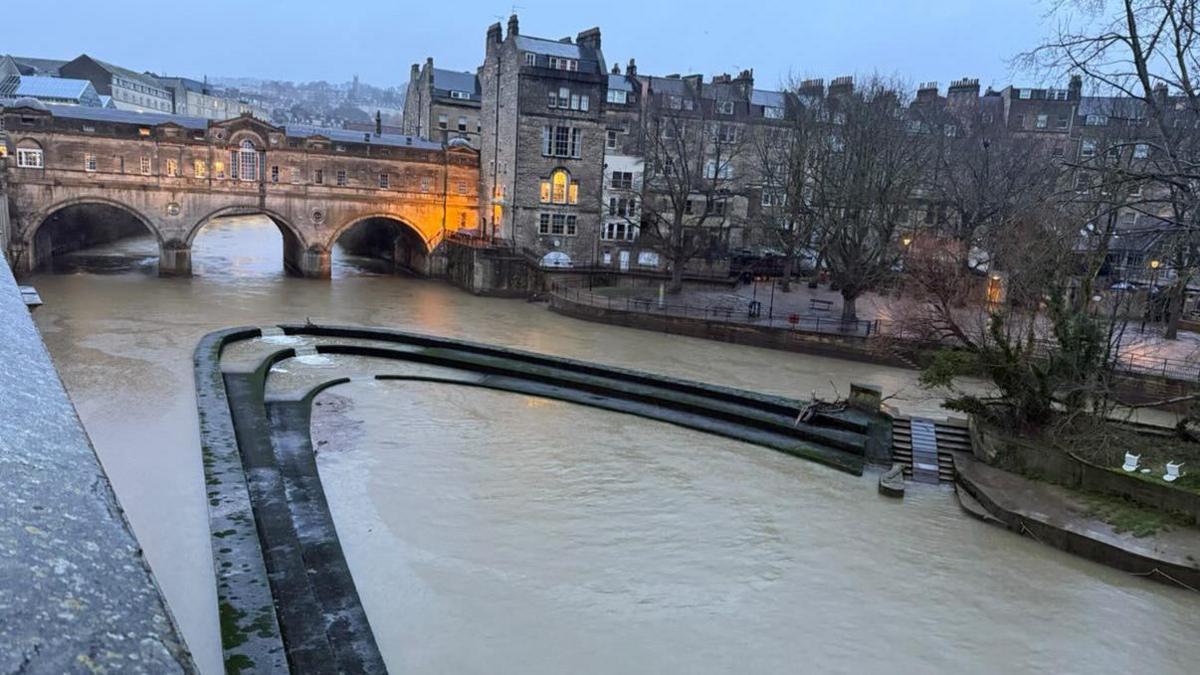 A UGC image of Pulteney Weir in Bath, where the river level is extremely low. The image shows the weir and the famous Pulteney bridge, and trees and other buildings in the background.