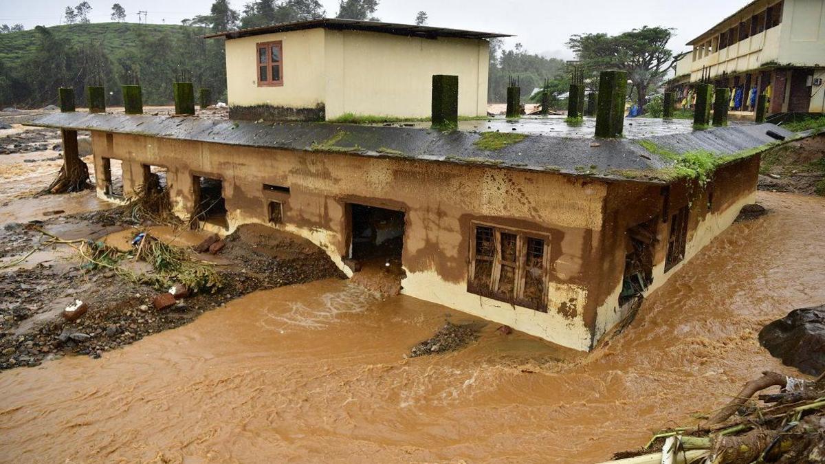 Floodwater runs through a house following landslides in Mylambadi, Wayanad district, Kerala, southern India, 30 July