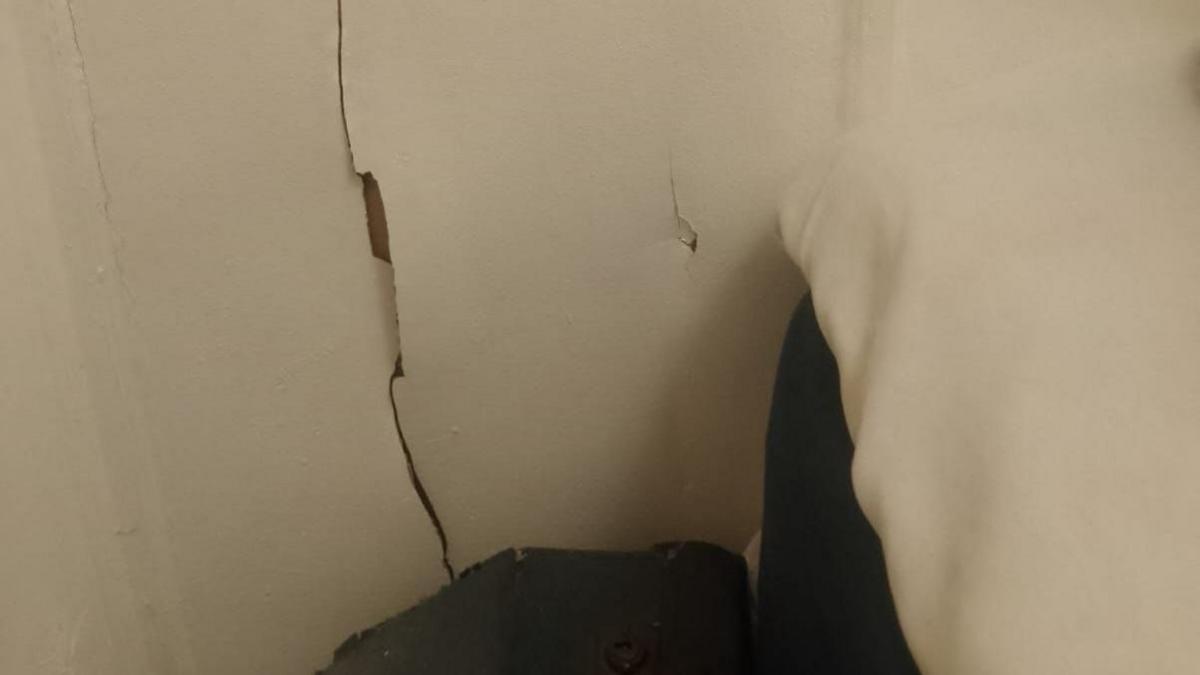 A wall with a hole in it.