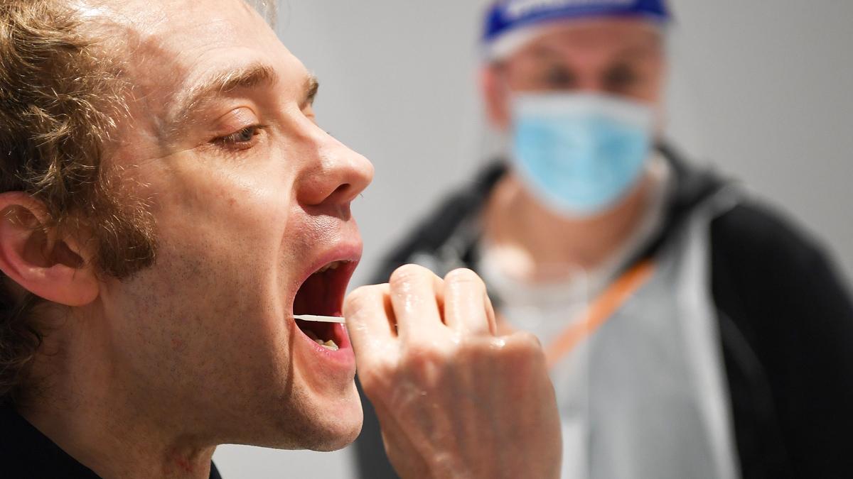 A man puts a swab in his mouth