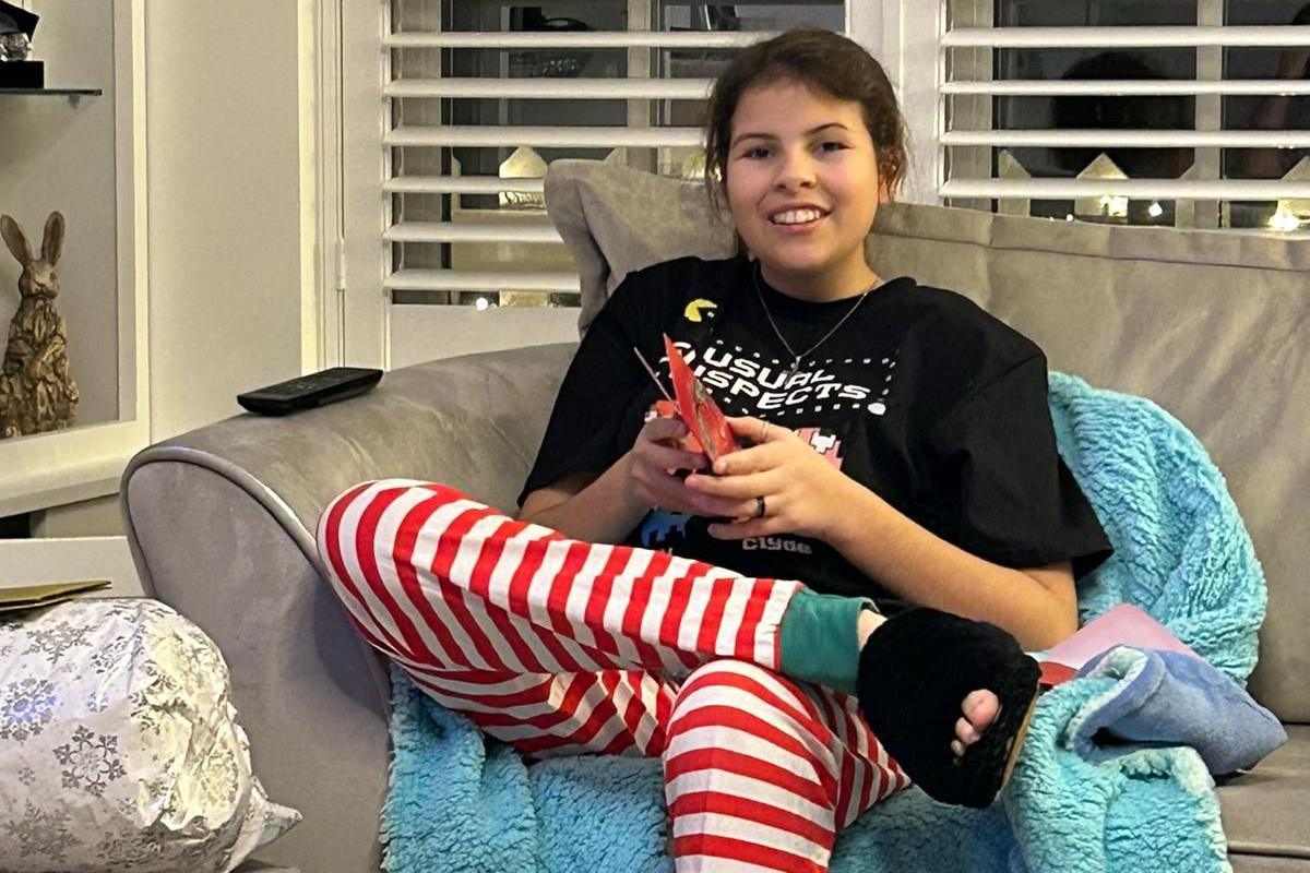 Brooke sitting on a sofa and smiling