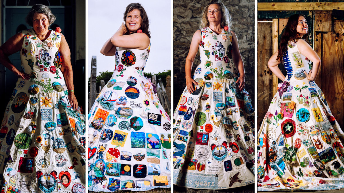 A composition image of four different modelling the Portland Dress. The dress itself is a white calico floor length dress with a v neck tank top style and blue ribbon laced on the back like a corset. It is covered in different colours emboirdery patches. From left to right, Hazel Smith has grey hair styled in a short bob, she is smiling at the camera and has one arm relaxed by her side while the other hand rests on her hip. Annerose Walker is smiling at the camera with her hands lifted up to the side of her face. She has shoulder length dark brown hair which is windswept away from her face. Sarah Partridge stands confidently with her arms by her sides and looks at the camera. She has long blonde curly hair. Poppy Hardwicke has her back to the camera, looking back over her shoulder and smiling. She has her hands on her hips and long dark brown hair.