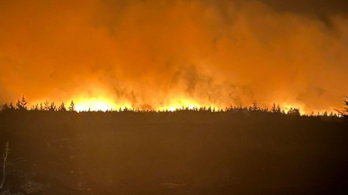 The moorland fire across North York Moors National Park at night.