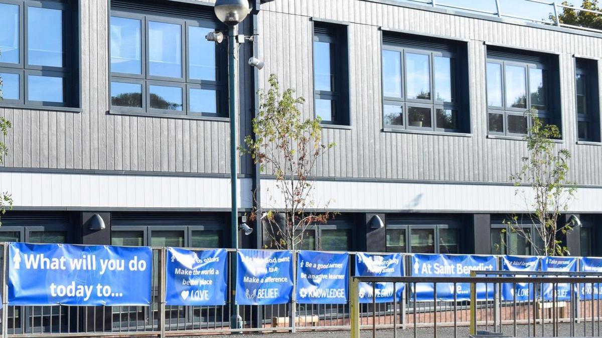 A photograph of the new science block. It is a building with grey panels and windows with black frames. 