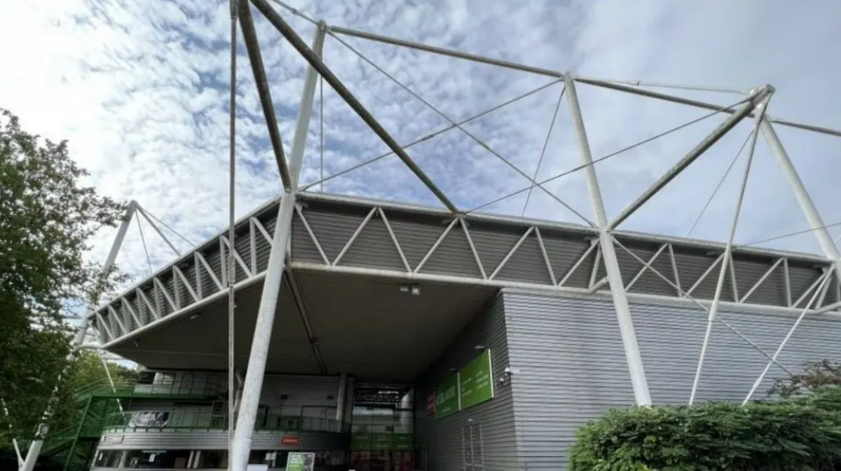 The Link Centre from the outside - a large building with metal-effect grey walls and a white tube frame around the outside. 