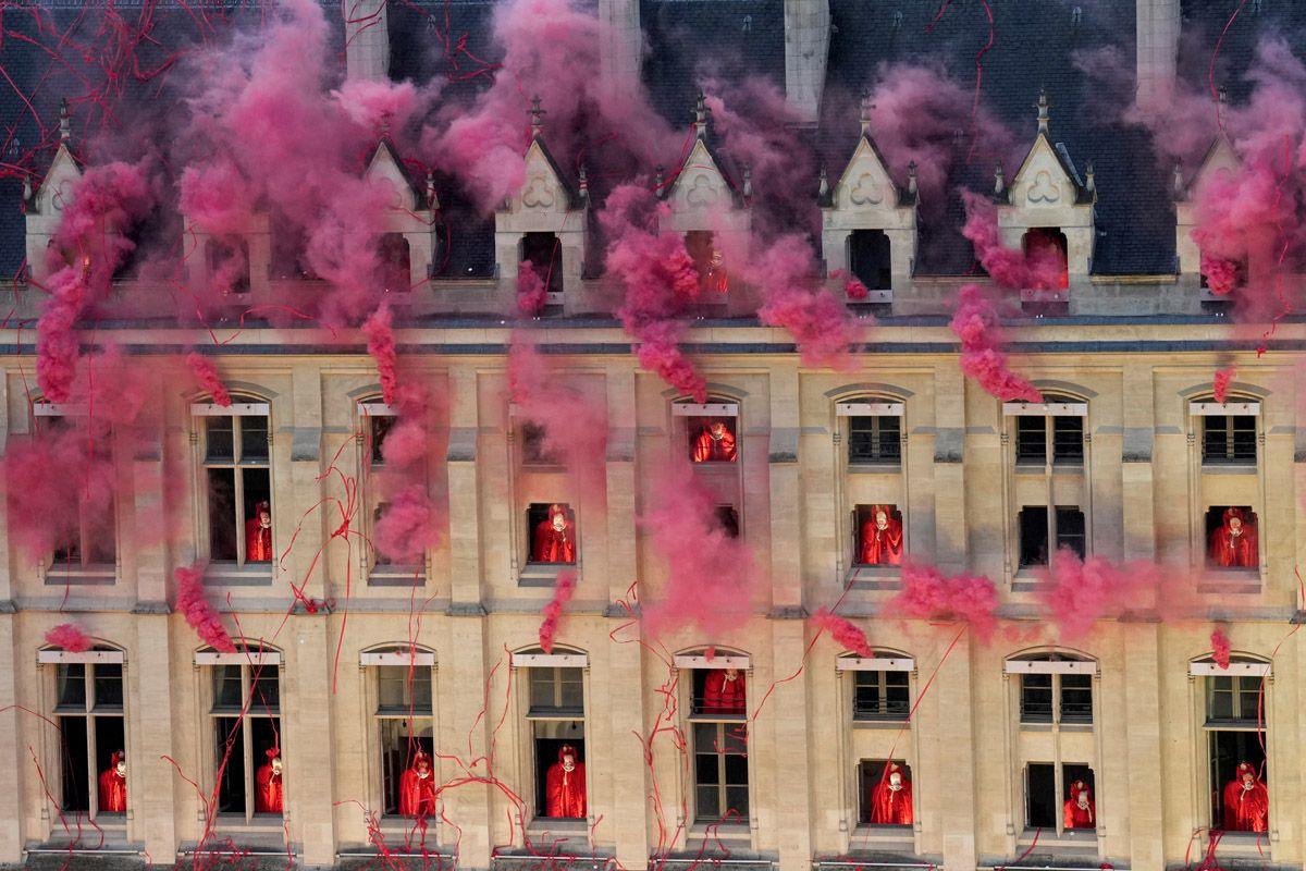 Smoke billows near windows as performers participate during the opening ceremony of the 2024 Summer Olympics