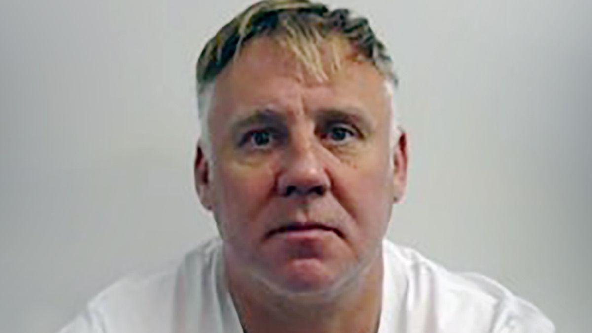 Police mugshot of Jamie Stevenson, who is looking directly at the camera. He has fair hair greying at the sides and is wearing a white T-shirt