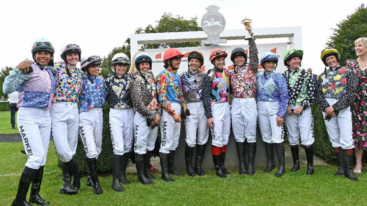 The 12 women competing in the Markel Magnolia Cup on Thursday, 31 July. All 12 are wearing white trousers and boots, alongside shirts with different patterns.