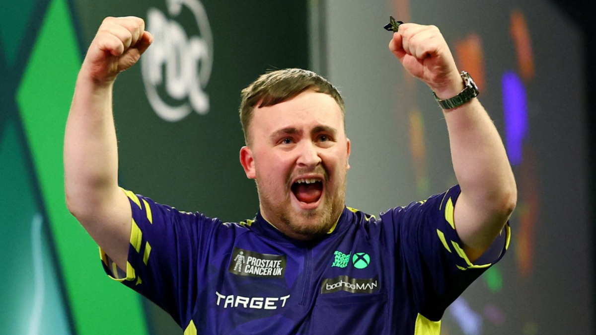 Luke Littler celebrates by raising his fists in the air after winning the 2025 PDC World Darts Championship final against Michael van Gerwen