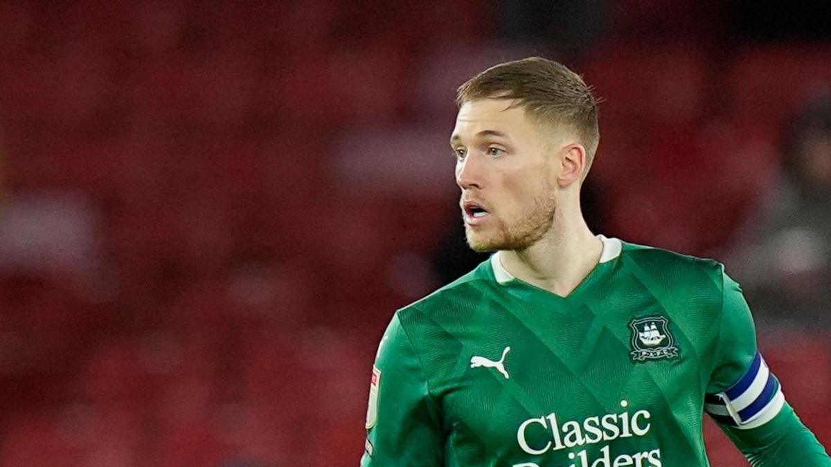 Lewis Gibson takes to the field for Plymouth Argyle earlier this season