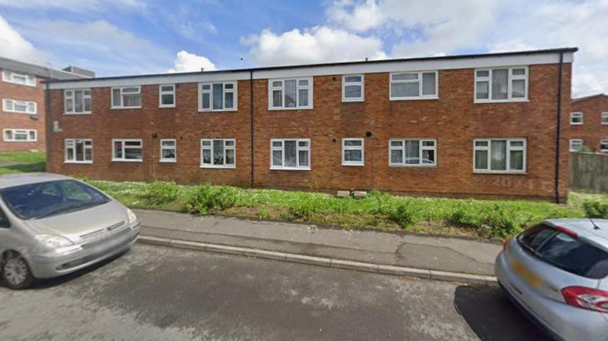 A picture taken from google street view showing a two-storey block of flats